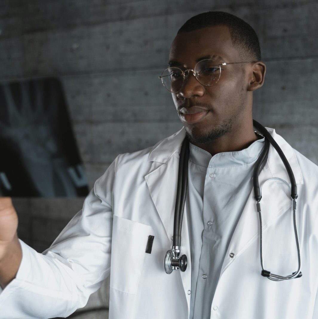 Professional doctor with eyeglasses reviewing an X-ray indoors.