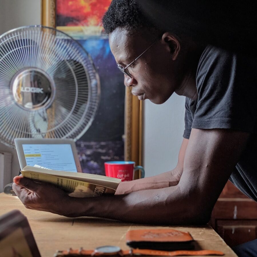 man reading a book at a desk